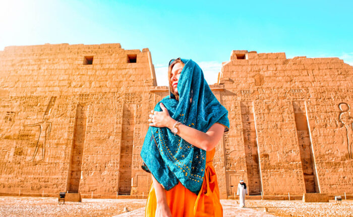 A great photo for a girl in front of the face of the temple of habo in luxor