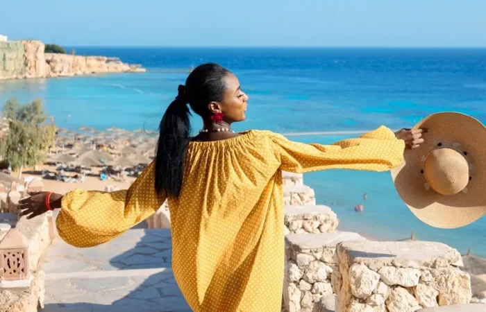 Female tourist on a Red Sea holiday overlooking a tropical beach and turquoise water in Egypt