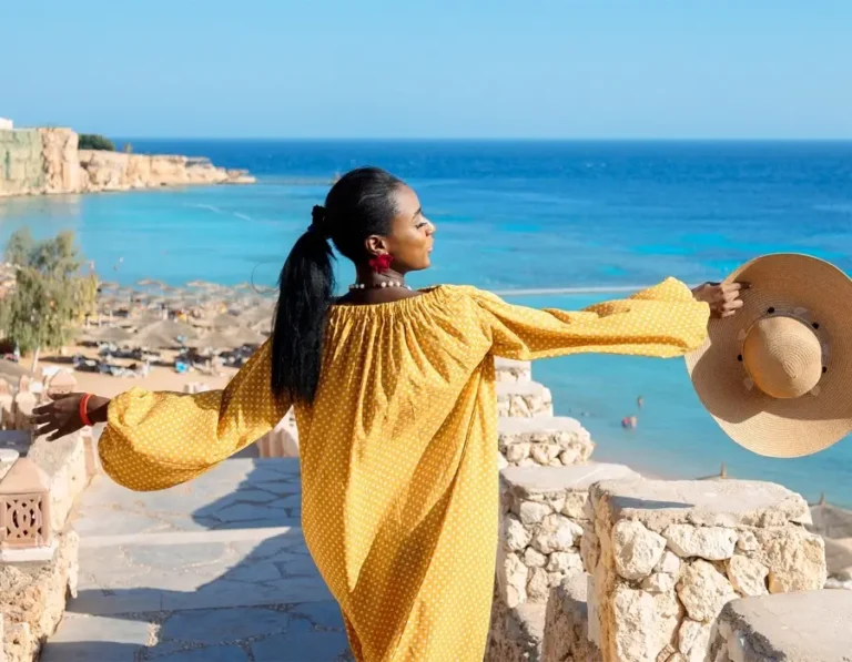 Female tourist on a Red Sea holiday overlooking a tropical beach and turquoise water in Egypt