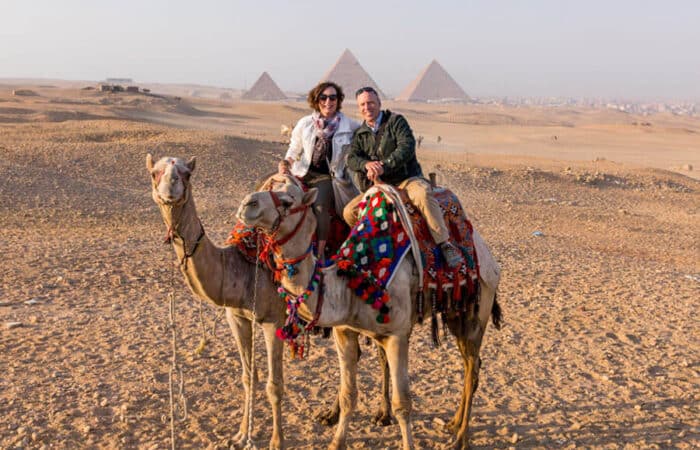 Sunset view over Nile River cruise boat with Luxor Temple in the background — 9 Day Egypt Itinerary