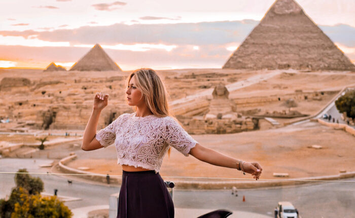 a great pictures of a girl in front of the pyramids of giza