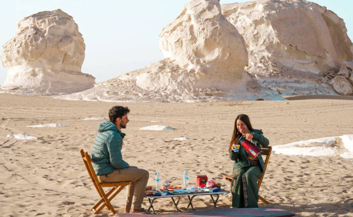 wonderful shot of a couple having breakfast at a camp in the White Desert