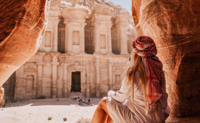 A wonderful shot of a girl from one of the caves in front of the Petra Temple in Jordan