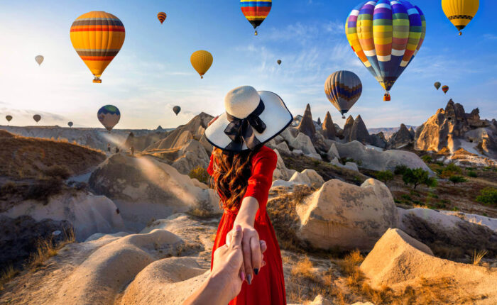 A wonderful shot of a tourist in Cappadocia Turkey with hot air balloons